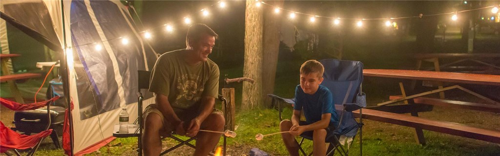 park campground father and son around fire pit
