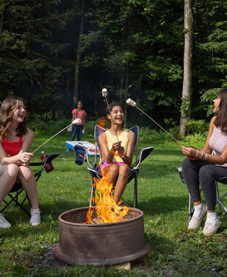 Laughing and eating smores around a fire